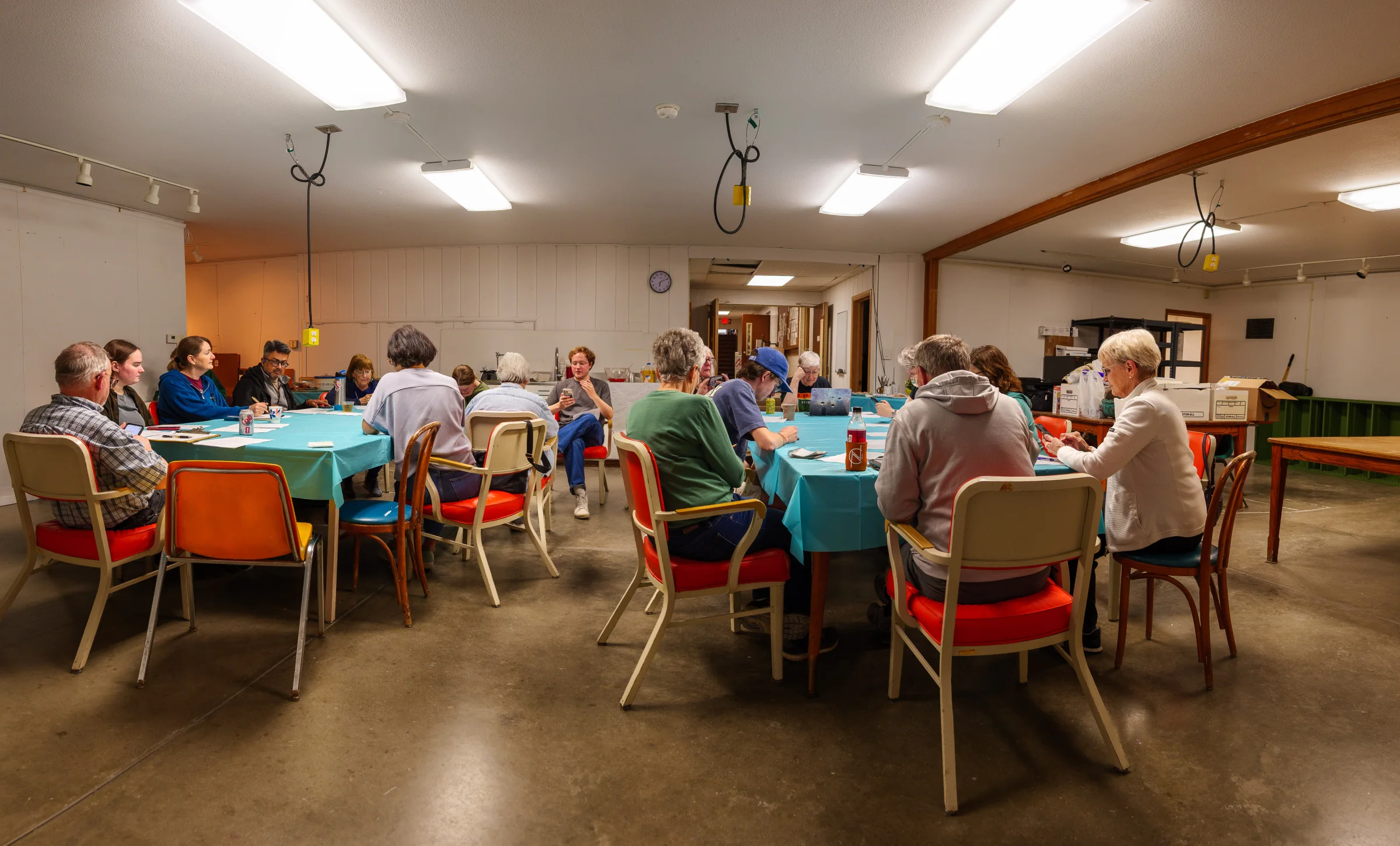 Artists creating together around tables in CASA's studio